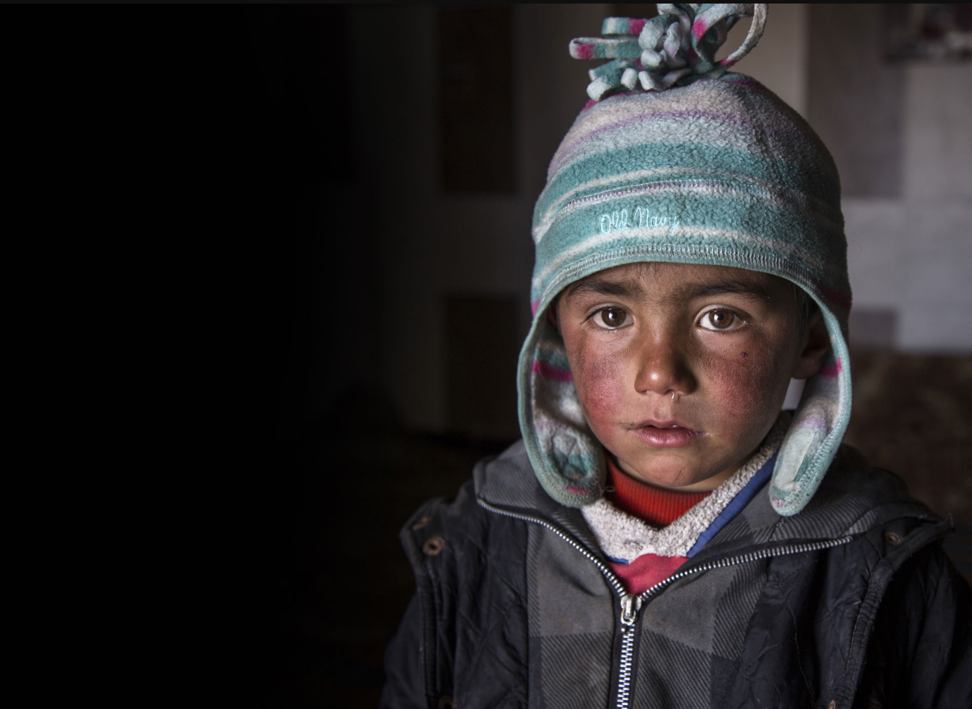 Refugee boy with a hat